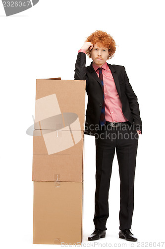 Image of attractive businessman with big boxes