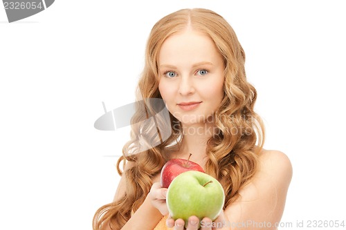 Image of young beautiful woman with green and red apples