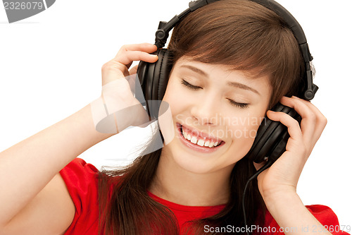 Image of happy teenage girl in big headphones