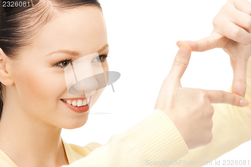 Image of lovely woman creating a frame with fingers