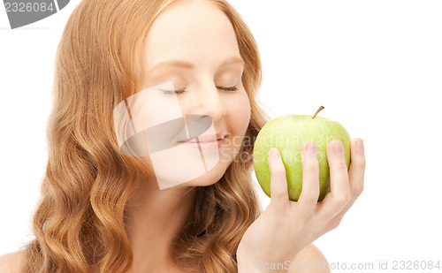 Image of young beautiful woman with green apple