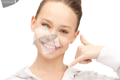Image of teenage girl making a call me gesture