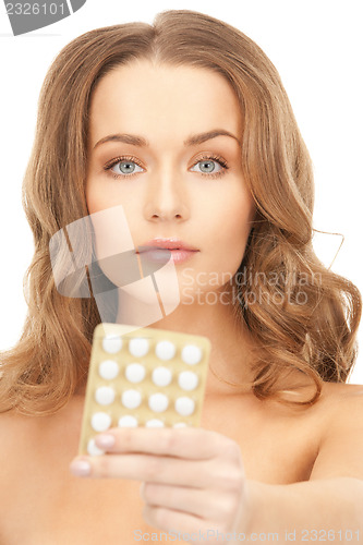 Image of young beautiful woman with pills 