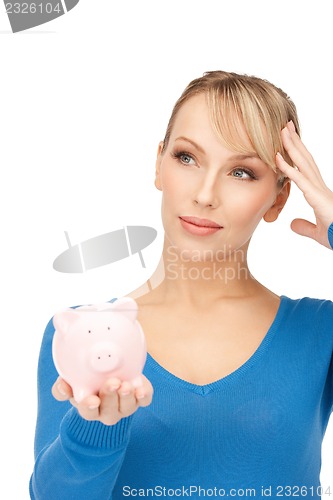 Image of lovely woman with piggy bank