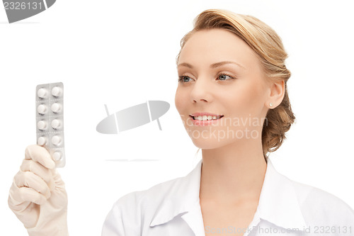 Image of attractive female doctor with pills