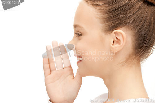 Image of teenage girl whispering gossip