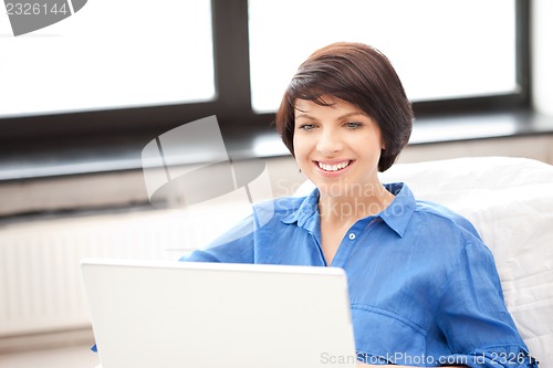 Image of happy woman with laptop computer