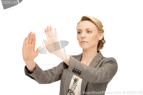 Image of businesswoman working with something imaginary