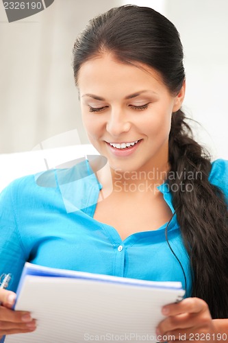 Image of happy woman with big notepad