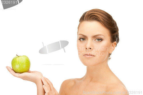 Image of young beautiful woman with green apple