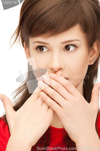 Image of teenage girl with palms over mouth