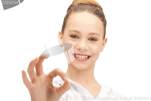 Image of lovely teenage girl showing ok sign