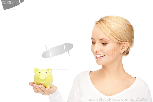 Image of lovely woman with piggy bank