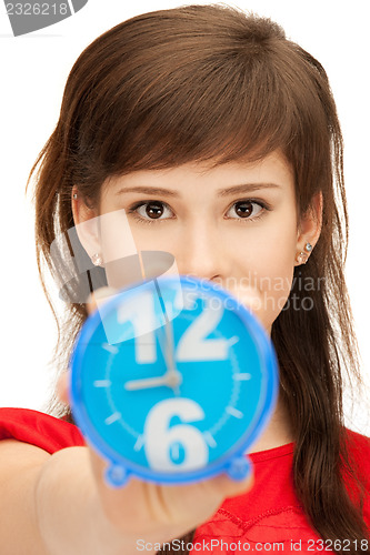 Image of teenage girl holding alarm clock