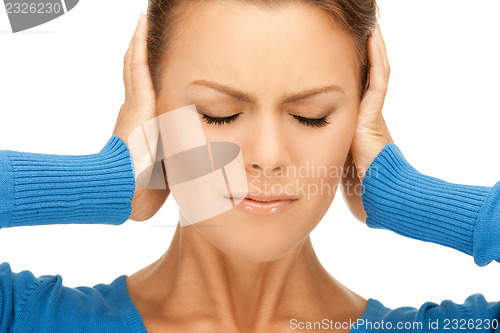 Image of woman with hands on ears