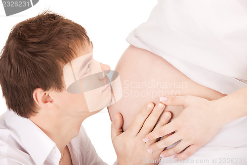 Image of male face and pregnant woman belly