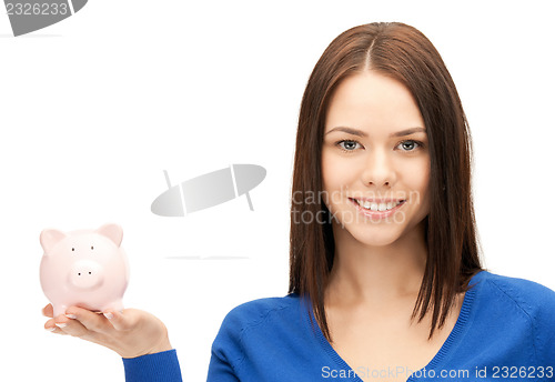 Image of lovely woman with piggy bank