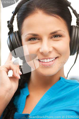 Image of happy teenage girl in big headphones