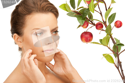 Image of lovely woman with apple twig