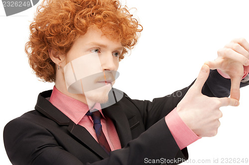 Image of handsome man creating a frame with fingers