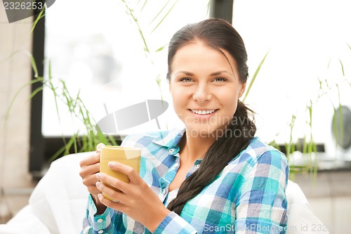 Image of lovely housewife with mug