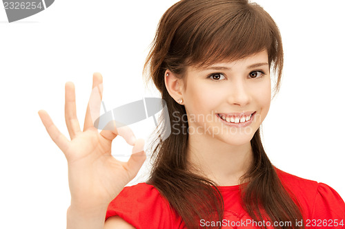 Image of lovely teenage girl showing ok sign
