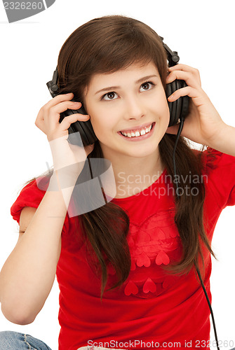 Image of happy teenage girl in big headphones