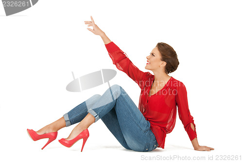 Image of lovely woman in red blouse and jeans