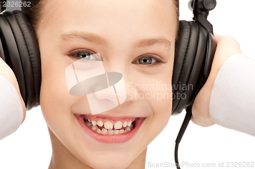 Image of happy teenage girl in big headphones
