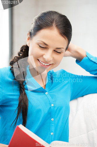 Image of happy and smiling woman with book