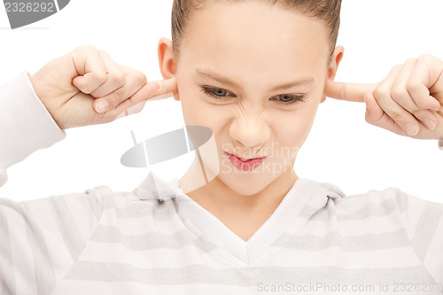 Image of teenage girl with fingers in ears