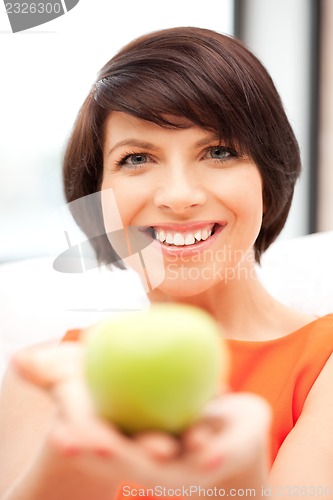 Image of lovely housewife with green apple