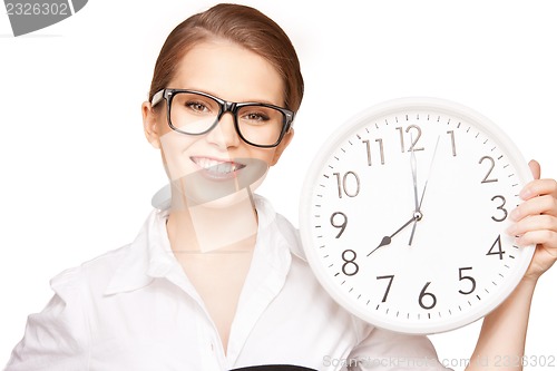Image of woman holding big clock