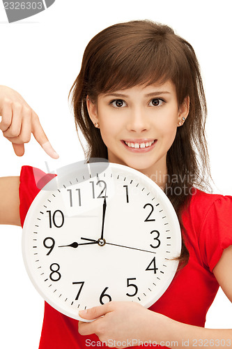 Image of teenage girl holding big clock