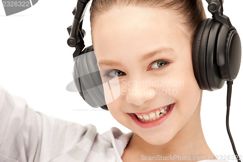 Image of happy teenage girl in big headphones