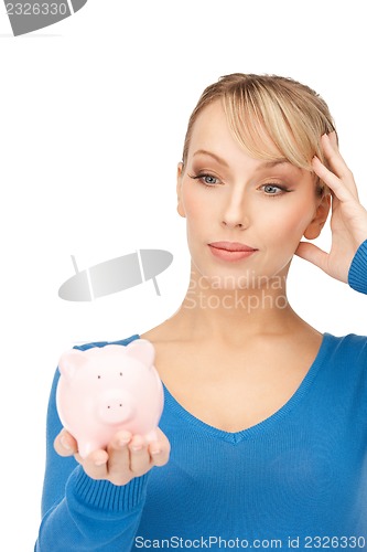 Image of lovely woman with piggy bank