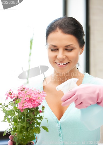 Image of lovely housewife with flower