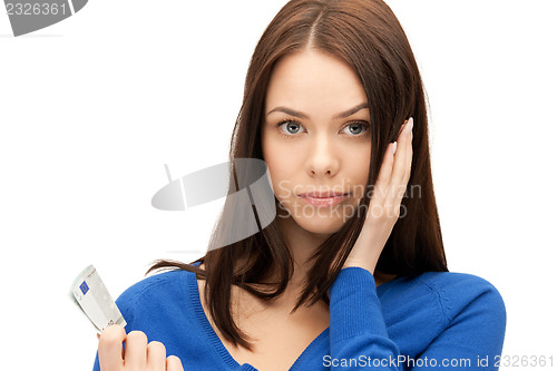 Image of unhappy woman with euro cash money