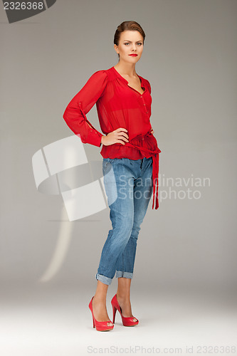 Image of lovely woman in red blouse and jeans