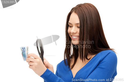 Image of woman with magnifying glass and euro cash money