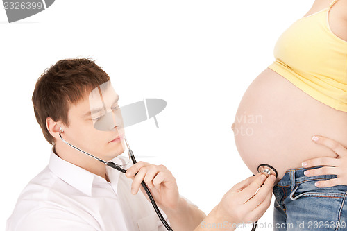 Image of doctor and pregnant woman belly