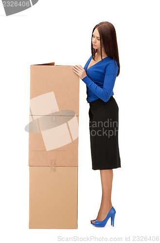 Image of attractive businesswoman with big boxes