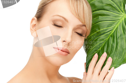 Image of woman with green leaf