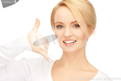 Image of woman making a call me gesture