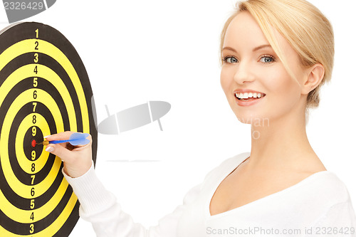 Image of businesswoman with dart and target