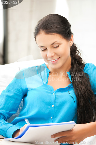 Image of happy woman with big notepad