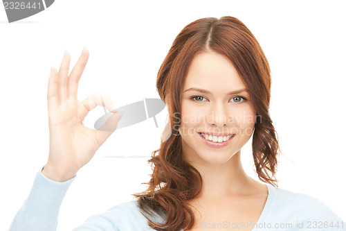 Image of lovely teenage girl showing ok sign