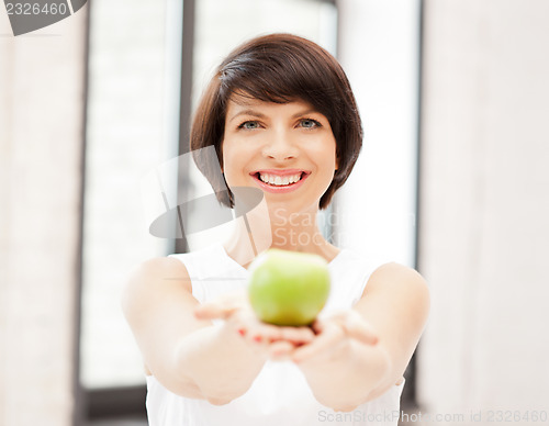 Image of lovely housewife with green apple