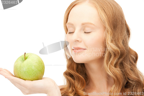 Image of young beautiful woman with green apple