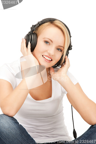 Image of  happy teenage girl in big headphones